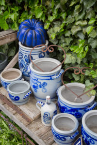 Old wooden bench, stoneware pots and bellarmines in the garden Old wooden bench, stoneware pots and bellarmines in the garden
